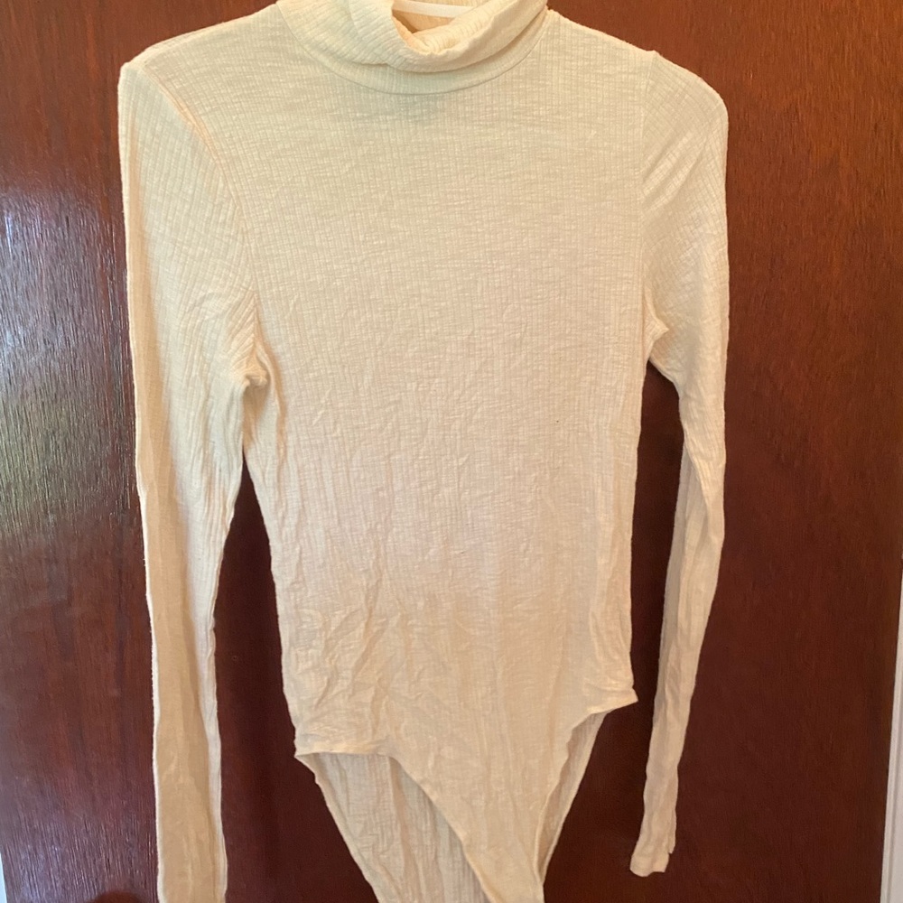 white turdleneck body suit